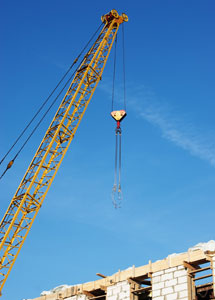 Crane working on concrete block building